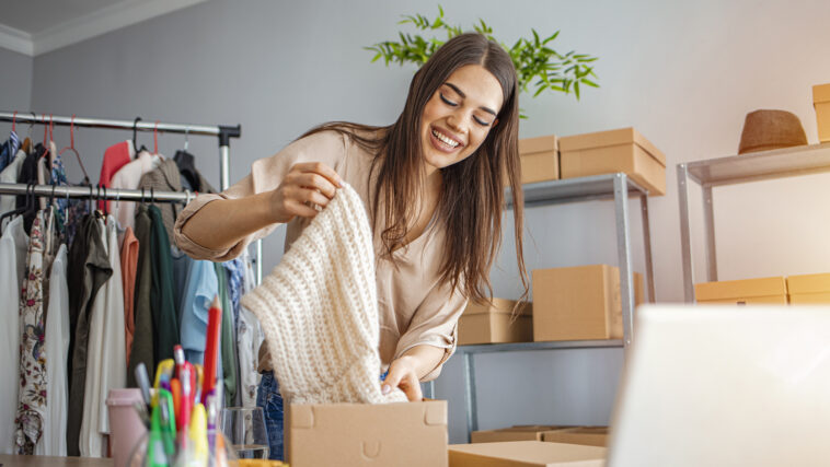 Women, owener of small business packing product in boxes, prepar