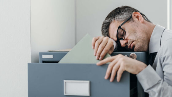Man, Businessman, Office worker, Sleeping, Fatigue, Tired, Resting, Filing cabinet, Exhausted, Sleepy, Lazy, Unproductive, Bored, Overwork, Overworked, Stress, Sleep deprivation, Sleepless, Restless, Sleepiness, Narcolepsy, Narcoleptic, Inefficient, Clerk, Employee, Manager, Executive, White collar, Glasses, Asleep, Workplace, Inefficiency, Sleep disorders, Leaning, Napping, Professional occupation, Exhaustion, Job