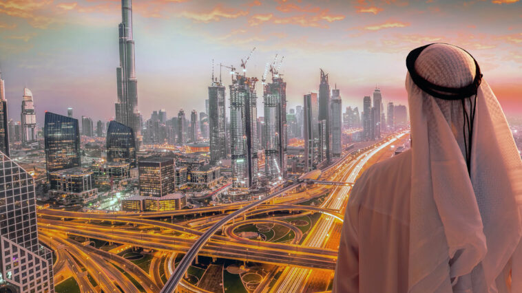 Arabian man in Dubai against colorful sunset in United Arab Emirates, Burj Khalifa, Sunser in Dubai, Night Scene, Glittering Dubai, dubai, khalifa, burj, city, uae, united, arab, emirates, downtown, building, tallest, modern, tower, architecture, urban, skyscraper, skyline, road, marina, arabian, evening, man, people, male, arabic, drone, aerial view, sea, vacation