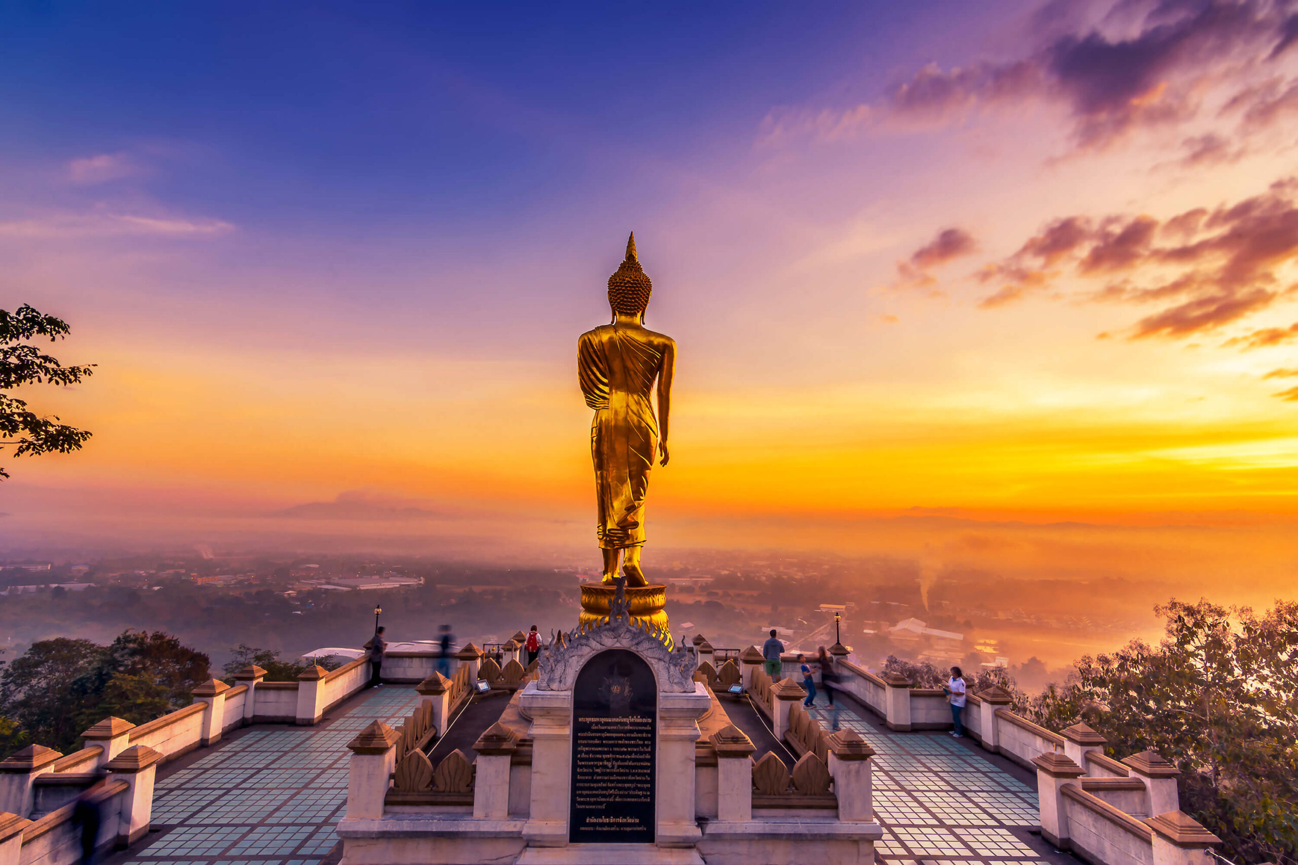 Golden buddha statue in Khao Noi temple at sunrise, Nan Province, Thailand