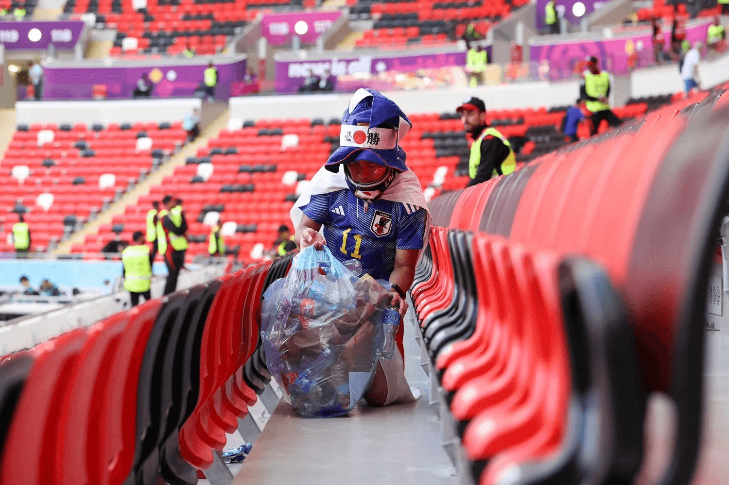 Japanese fans tidying up the stadium after a game