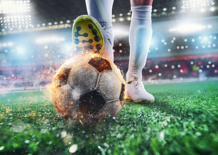 Close up soccer striker ready kicks fiery ball stadium