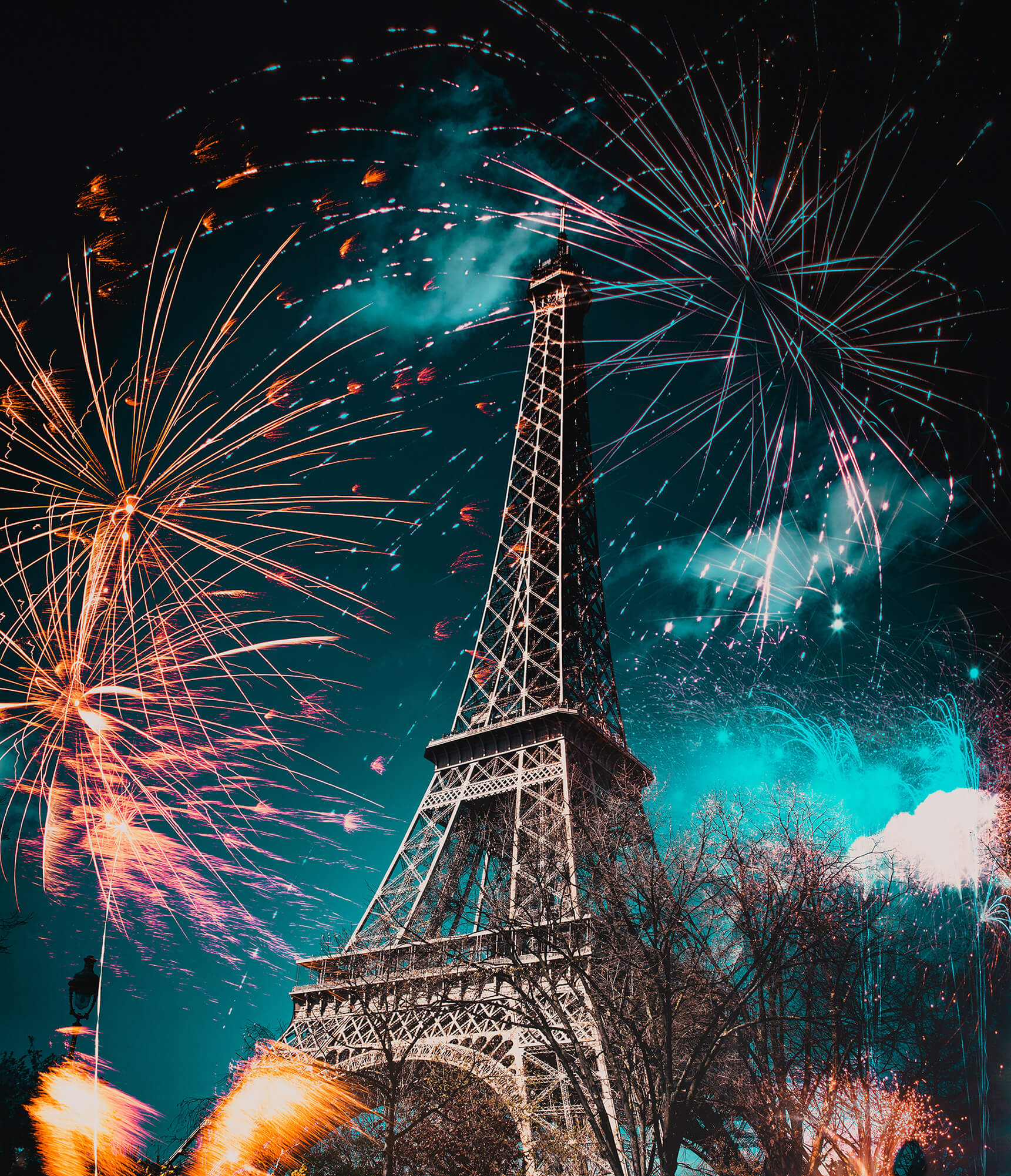 fireworks around Eiffel tower New Year in Paris